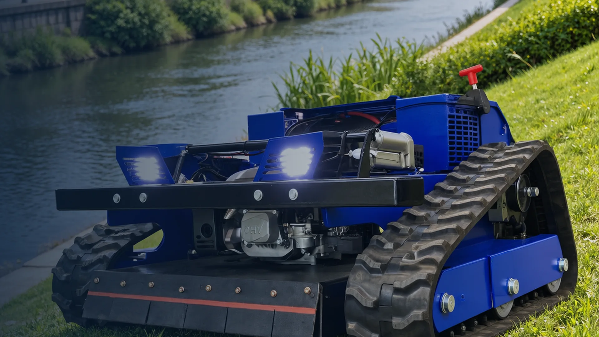 Blue tracked remote control mower working on grass