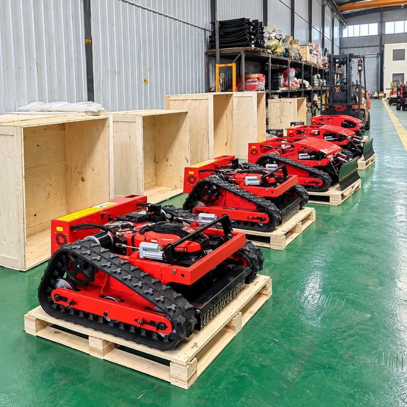 Red tracked mowers beside packaging crates